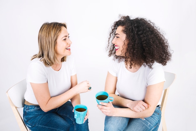 Women with mugs having conversation