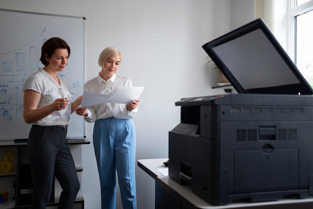 Photo women at work in the office using printer