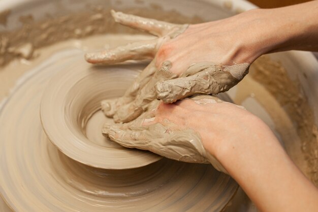 Women working on the potters wheel close up