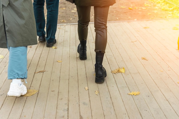 Women39s legs in leather pants and boots walk among crowd of passersby