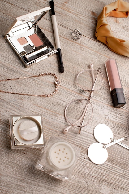 womens cosmetics and accessories on a wooden table