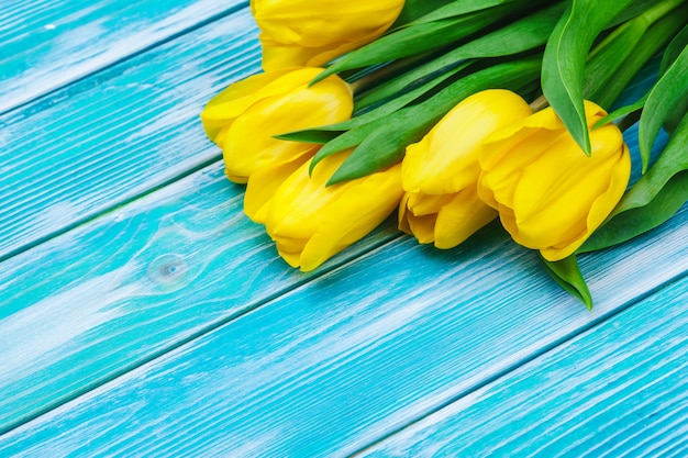 Womens day. Tulips bouquet on wooden planks , copy space, top view