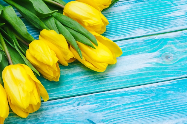 Womens day. Tulips bouquet on wooden planks