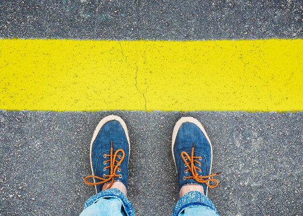 Womens feet in sneakers standing at the line