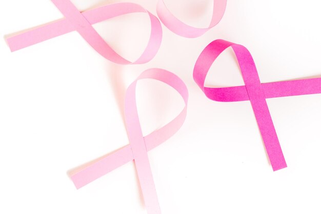 Womens health symbol in pink ribbon on a white bacckground.