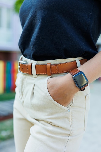 Womens leather belt for trousers A brown belt on a womans waist