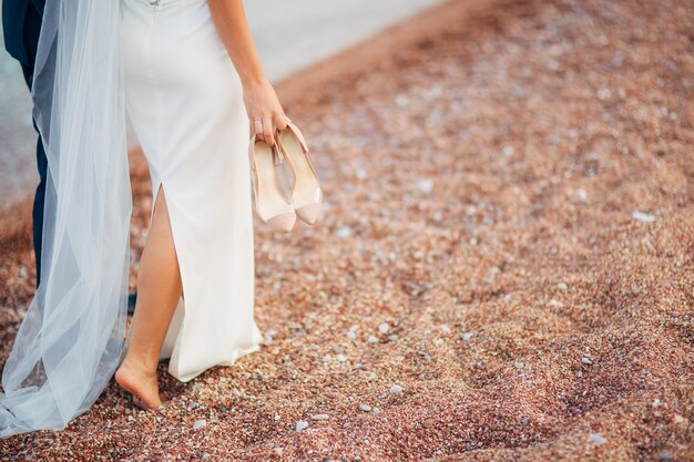 Womens and mens feet in the sand