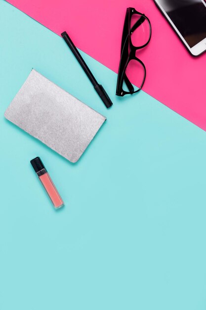 Womens office materials on pink and blue background. Flat lay, Top view. Minimalism