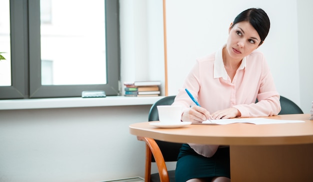 Wonam work with papers in office room