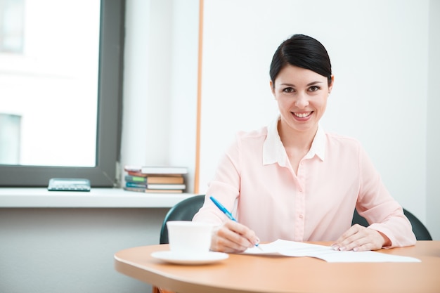 Wonam work with papers in office room