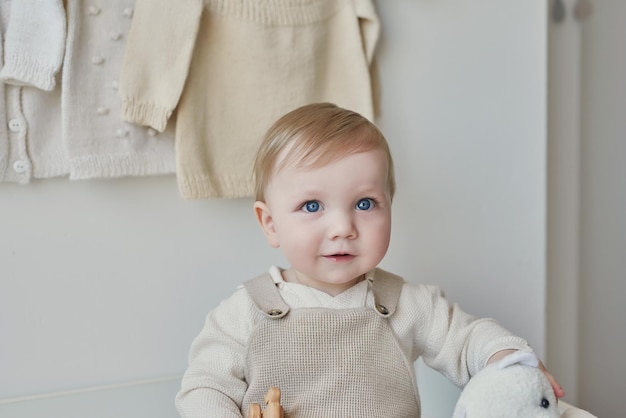 Wonderful baby boy with blue eyes Child playing with toys in nursery Early development kindergarten nursery playroom Children's Day Mother's Day