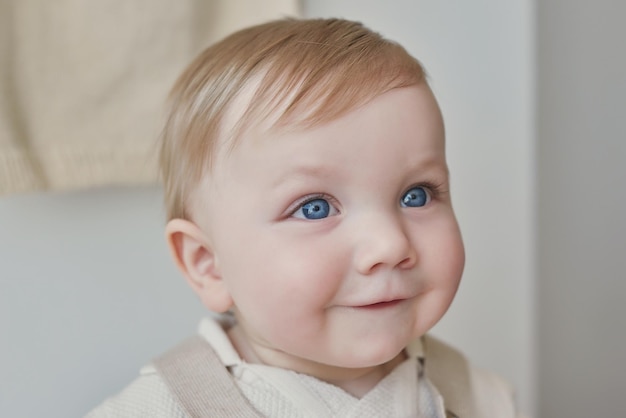 Wonderful baby boy with blue eyes Child playing with toys in nursery Early development kindergarten nursery playroom Children's Day Mother's Day