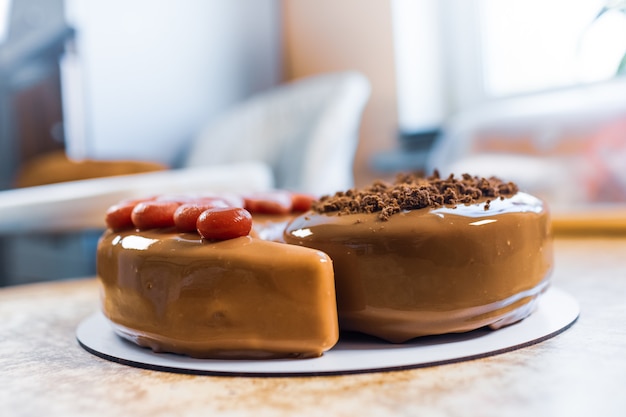 Wonderful delicious chocolate cake in the shape of Yin-Yang in a cozy light home kitchen on a wooden vintage table