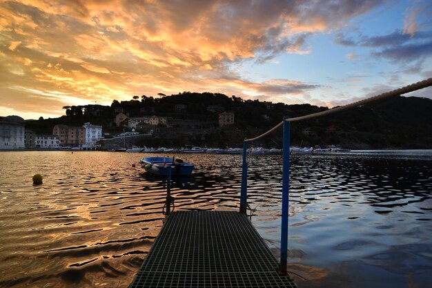 Wonderful sunrise on the beach of the bay of silence in liguria a dream atmosphere