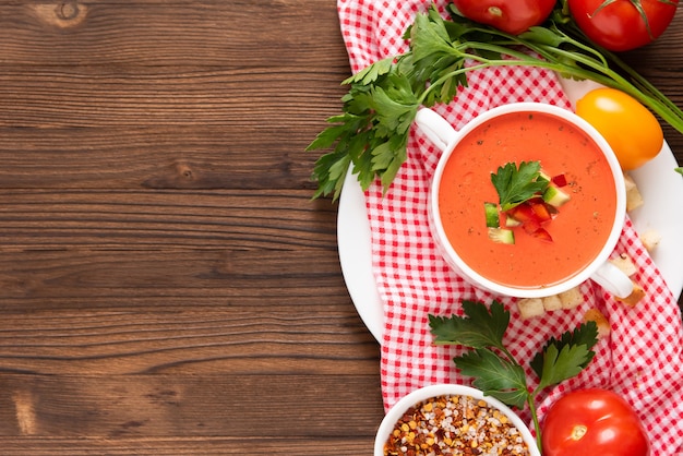 Wonderful tomato gazpacho soup with herbs and tomatoes. Top view. Copy space.