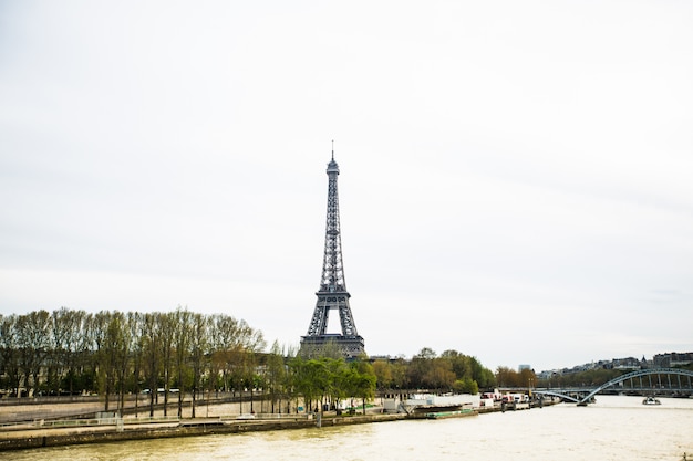 Wonderful view of Eiffel Tower in Paris. La Tour Eiffel with sky and meadows.