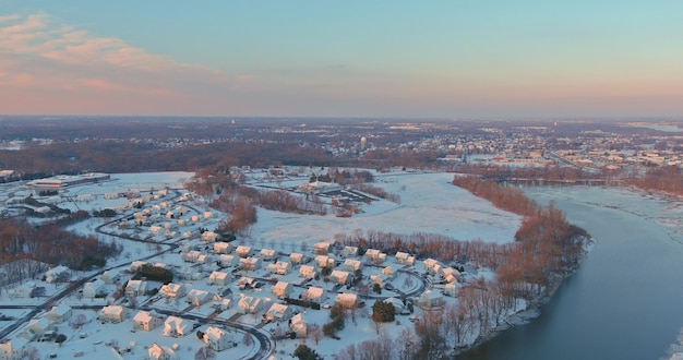 雪に覆われた素晴らしい冬の風景の屋根の家は、小さなアメリカの住宅地で空撮に覆われています