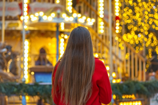 Wonderful young woman with long hair walking at the street fair