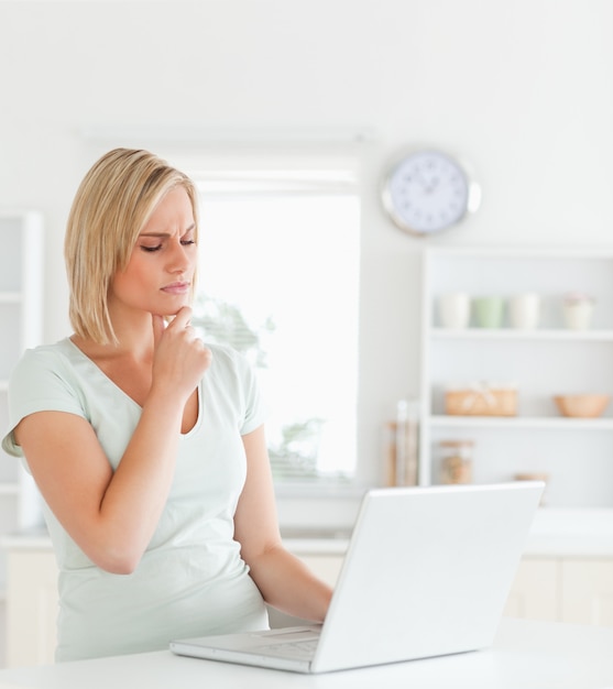 Wondering gorgeous woman looking at notebook