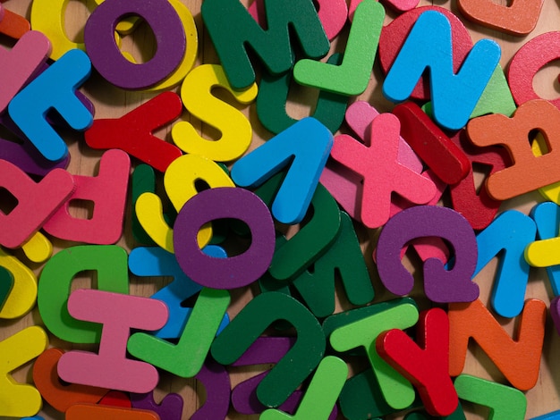 The  wood alphabet multi color on table for education or kid concept