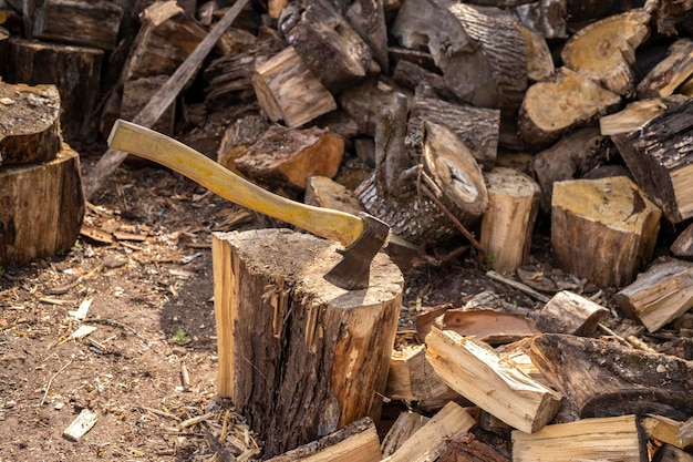 Wood axe and wood pile outdoor woodcutter logs