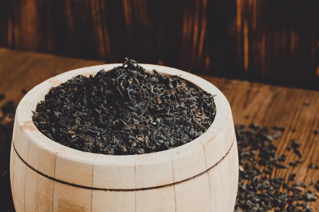 wood barrel filled with teon burnt wood.