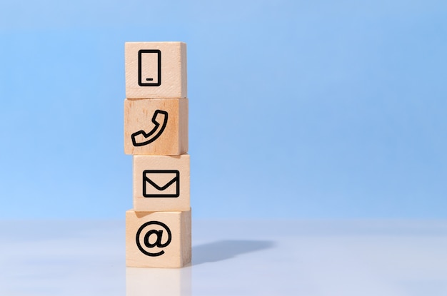 Wood block symbol telephone, address, email and mobile phone.