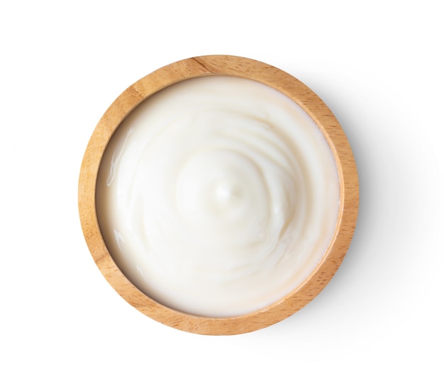 Wood bowl of yogurt on white table