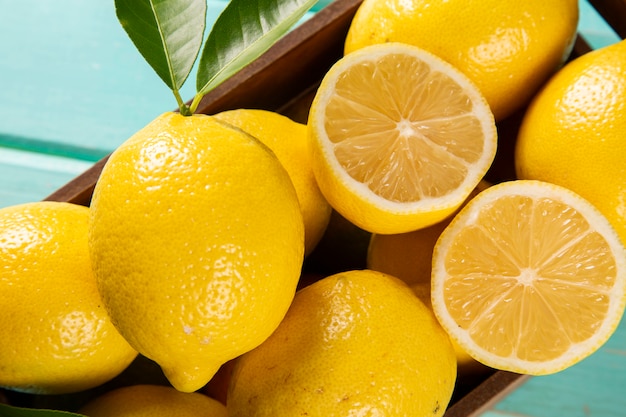 Wood box with lemons on green wooden background