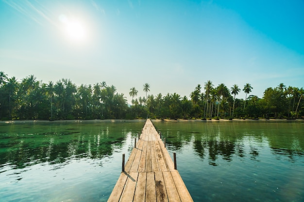 Wood bridge or pier on the beach and sea