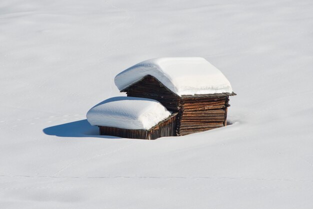 A wood cabin hut in the winter snow background