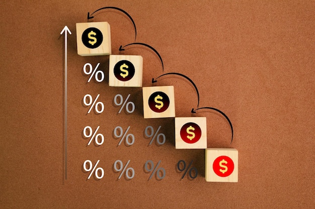 Wood cubes with money icons and percent The concept of earnings or income increases rate increase