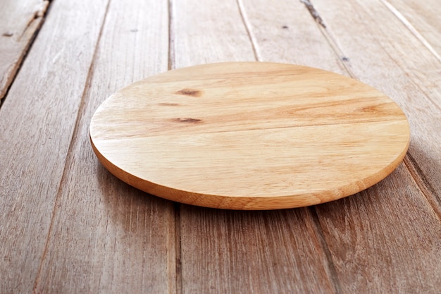 Wood cutting board on wooden background 