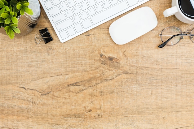 Wood desk table with computer gadgets and supplies