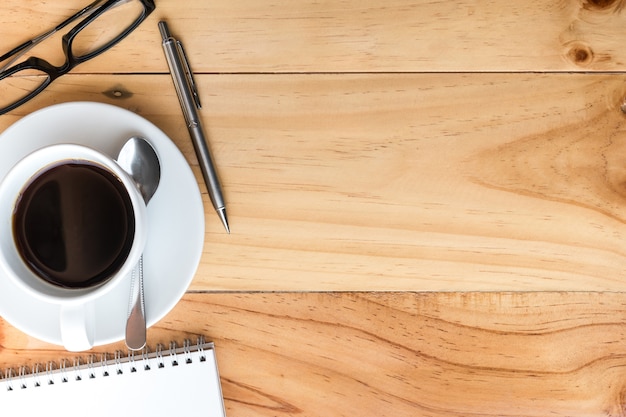 Wood desk with coffee and supplies