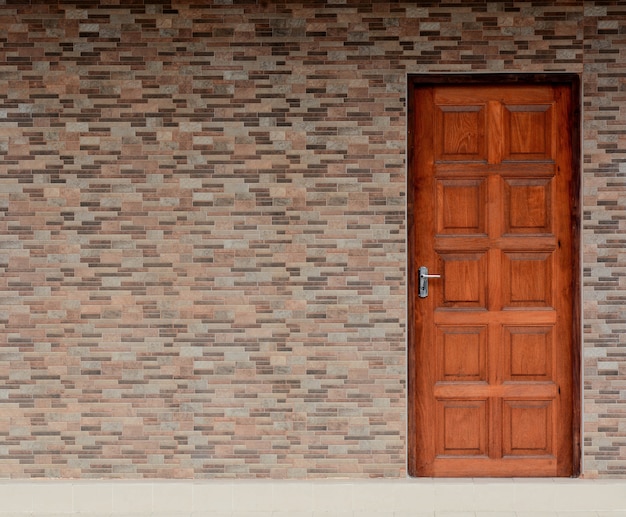 Wood door and ceramic brick wall