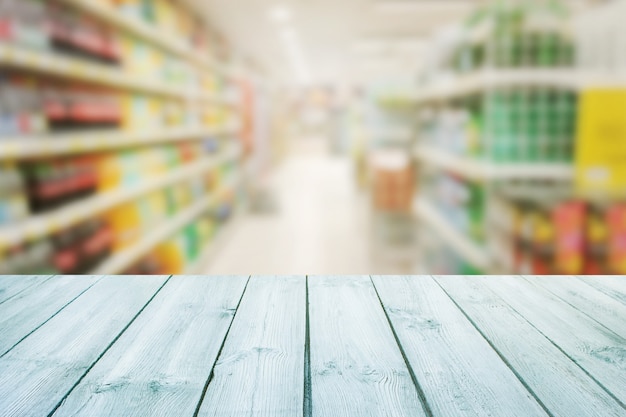 Wood empty table top on blurred of counter background supermarket.For montage product 