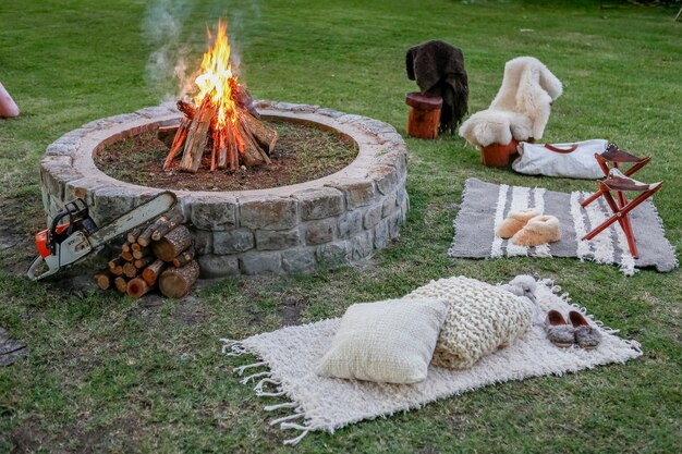 Wood fire with benches in the garden at sunset