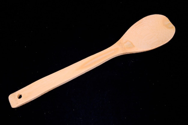 Wood Flatware Kitchen Tool over a Black Background