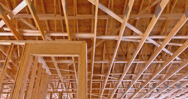 Wood frame building under construction in suburban new stick beams built with wall