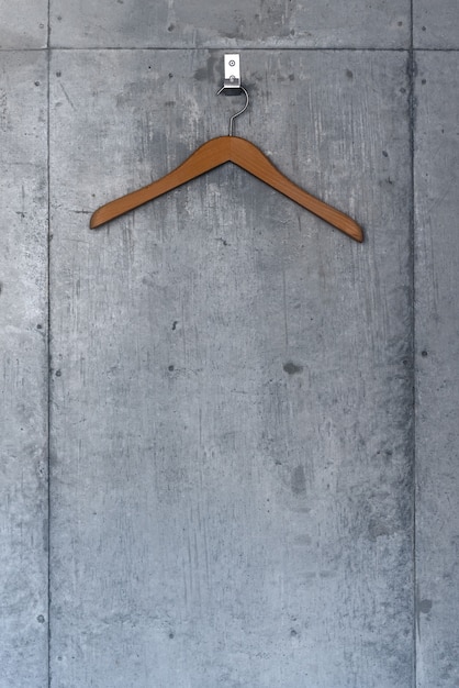 Photo wood hanger on a concrete wall