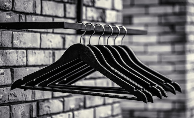 Wood hangers coat Many wooden black hangers on a rod Store concept sale design empty hangers Black and white