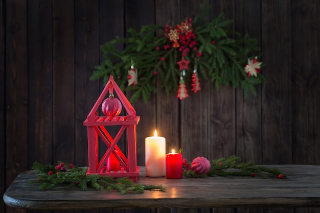 wood lantern with candles and Christmas branchs on wood