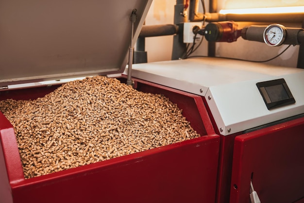 wood pellets heating stove boiler room in private household working on alternative energy biofuel sustainable future concept