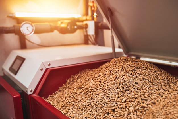 wood pellets heating stove boiler room in private household working on alternative energy biofuel sustainable future concept