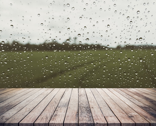 Wood plank with abstract water drop on glass background for product display