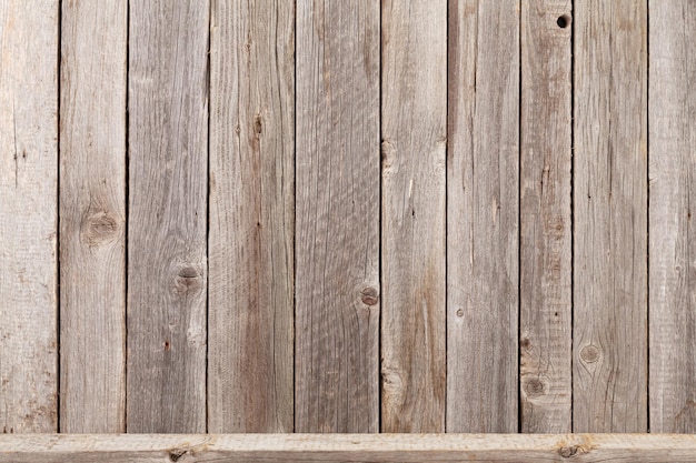 Wood shelf in front of wooden wall