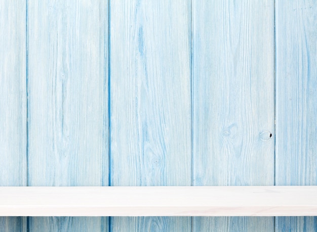 Wood shelf in front of wooden wall