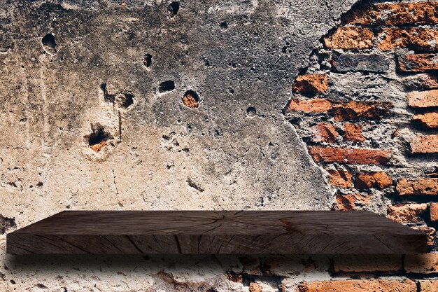 Wood shelf on old cement wall texture background.