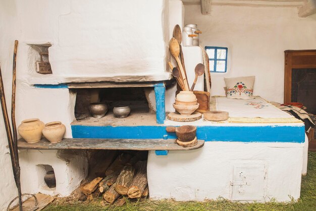 Wood stove and kitchen utensils in an old Ukrainian hut